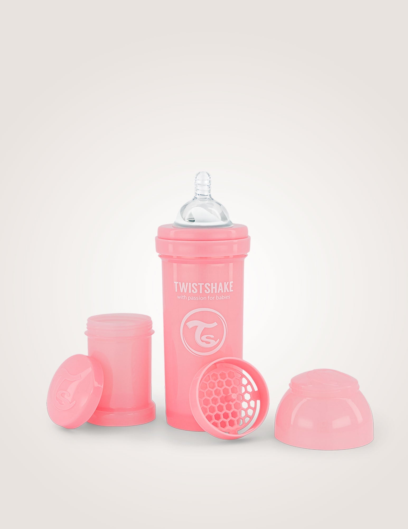 Pastel pink anti-colic baby bottle 260ml, Twistshake with integrated mixer, teat, and stackable powder containers.